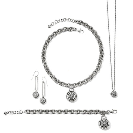 Silver jewelry set with chain necklace, bracelet, and earrings on a white background.