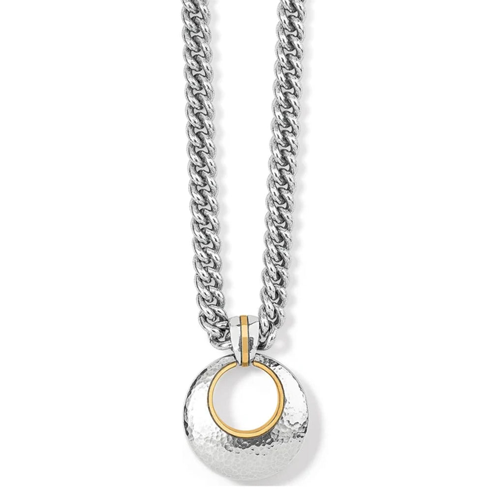 A silver-toned chain necklace with a hammered circular pendant featuring a gold-toned inner ring, shown on a plain white background.