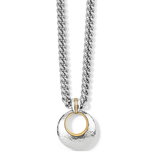 A silver-toned chain necklace with a hammered circular pendant featuring a gold-toned inner ring, shown on a plain white background.