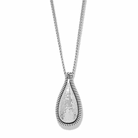 A silver teardrop pendant necklace with a hammered finish and a textured, ribbed border, suspended on a delicate silver chain against a white background.