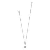 A delicate silver chain necklace with a small teardrop-shaped pendant, displayed against a solid white background.