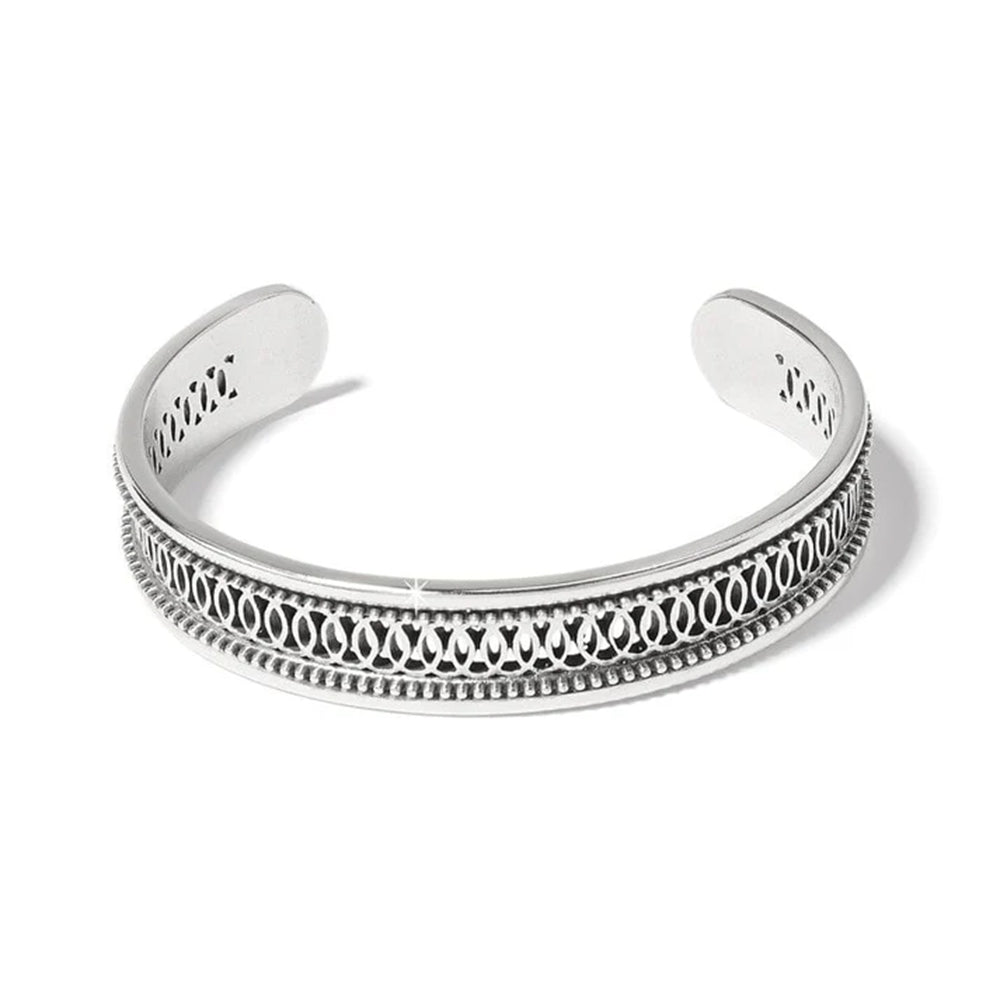 Silver bracelet with intricate design on a white background
