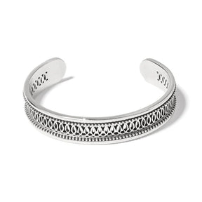 Silver bracelet with intricate design on a white background