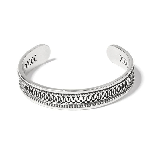 Silver bracelet with intricate design on a white background