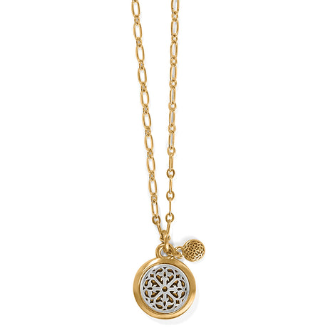 Gold necklace with a round pendant on a white background