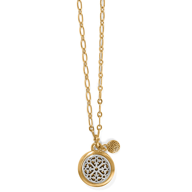 Gold necklace with a round pendant on a white background