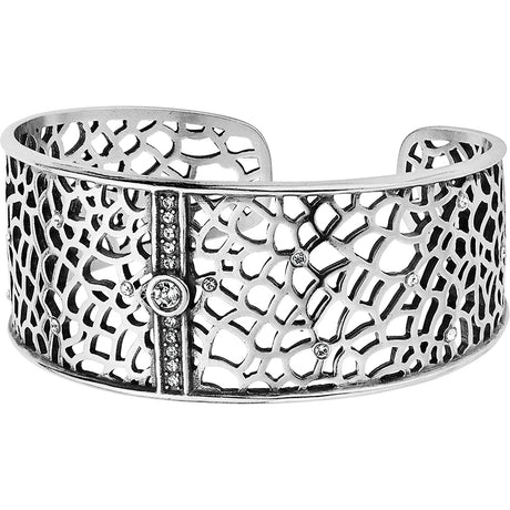 Silver cuff bracelet with intricate design on a white background