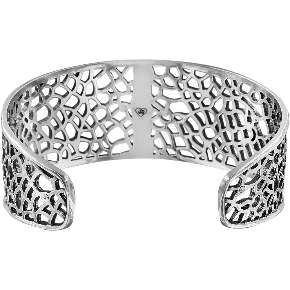 Silver bracelet with intricate openwork design on a white background