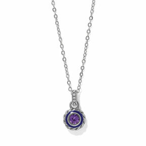 A silver chain necklace with a round pendant featuring a purple gemstone surrounded by a dark blue inlay and a textured silver border, shown on a white background.