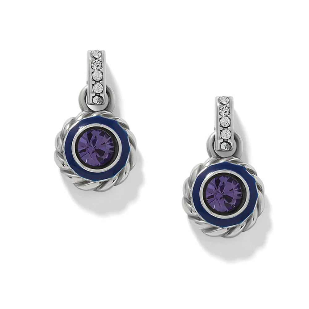 A pair of silver drop earrings with a central round purple crystal surrounded by a dark blue enamel ring, set in a twisted rope-style silver bezel. Each earring features a silver bail decorated with small clear round-cut crystals, all shown on a clean white background.
