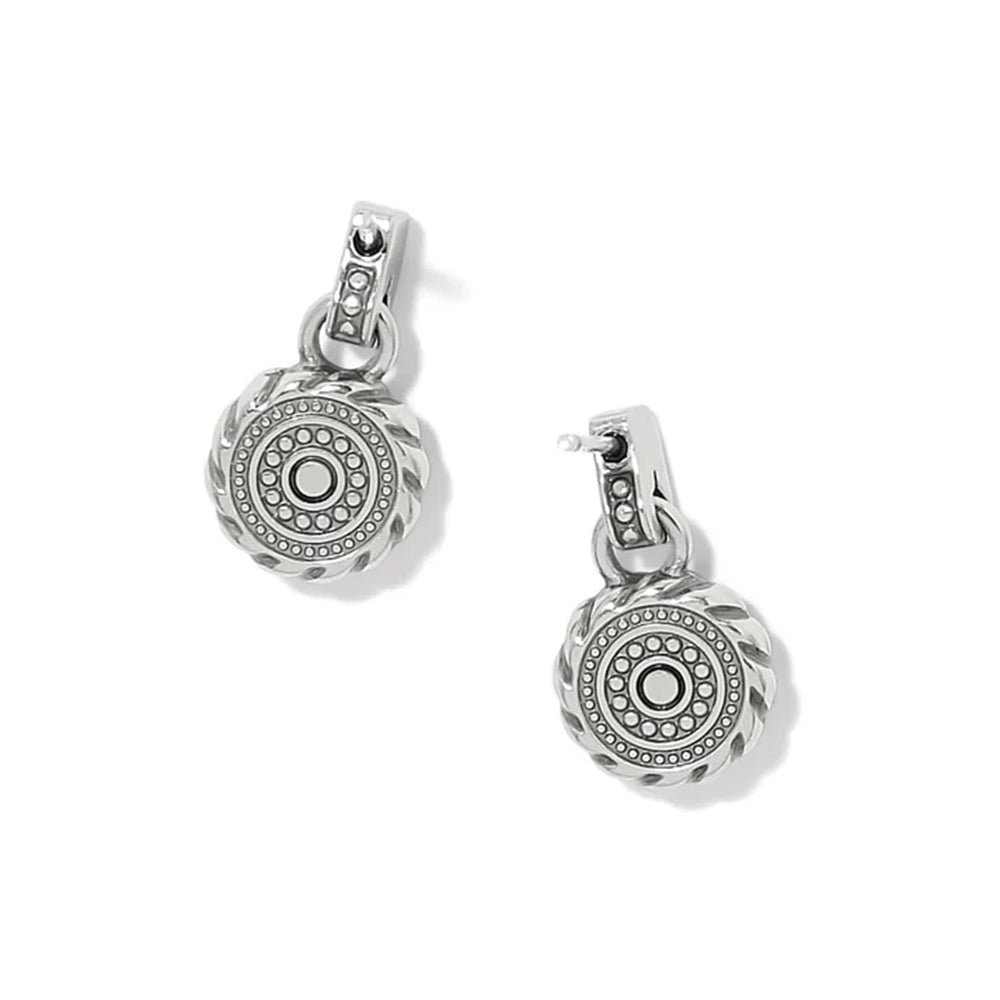 A pair of silver-toned drop earrings with circular medallion charms featuring a textured outer rim, a central round bezel-set stone, and smaller accent stones, shown on a clean white background.