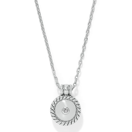 Silver necklace with a round pendant on a white background