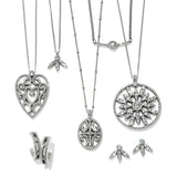 Collection of silver necklaces and pendants on a white background