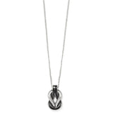 Necklace with a black and silver pendant on a white background