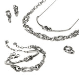 Silver jewelry set including necklace, bracelet, and earrings on a light background