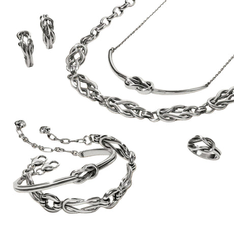 Silver jewelry set including necklace, bracelet, and earrings on a light background