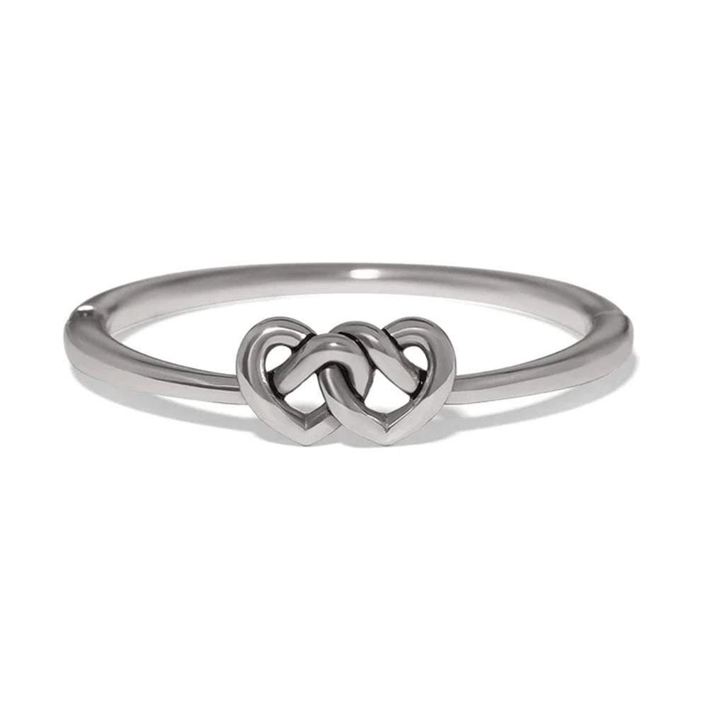 A polished silver ring featuring a central interlocking double heart design, shown on a clean white background.