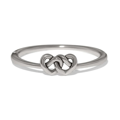 A polished silver ring featuring a central interlocking double heart design, shown on a clean white background.