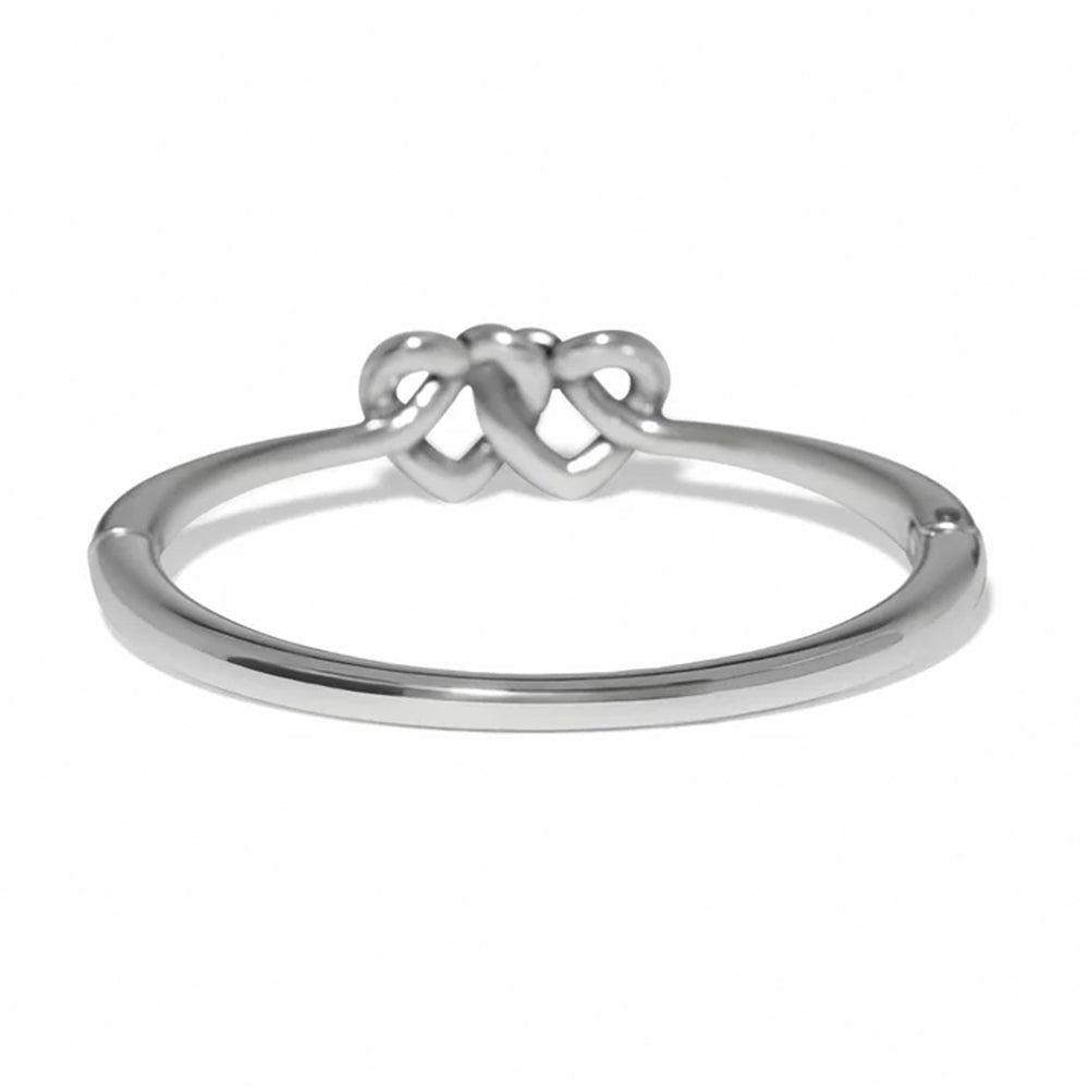 Silver ring with a knot design on a white background