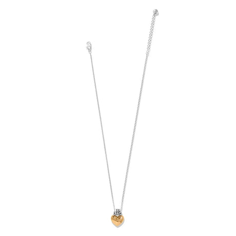A delicate silver chain necklace with a small heart-shaped pendant featuring a gold-toned center, displayed against a solid white background.