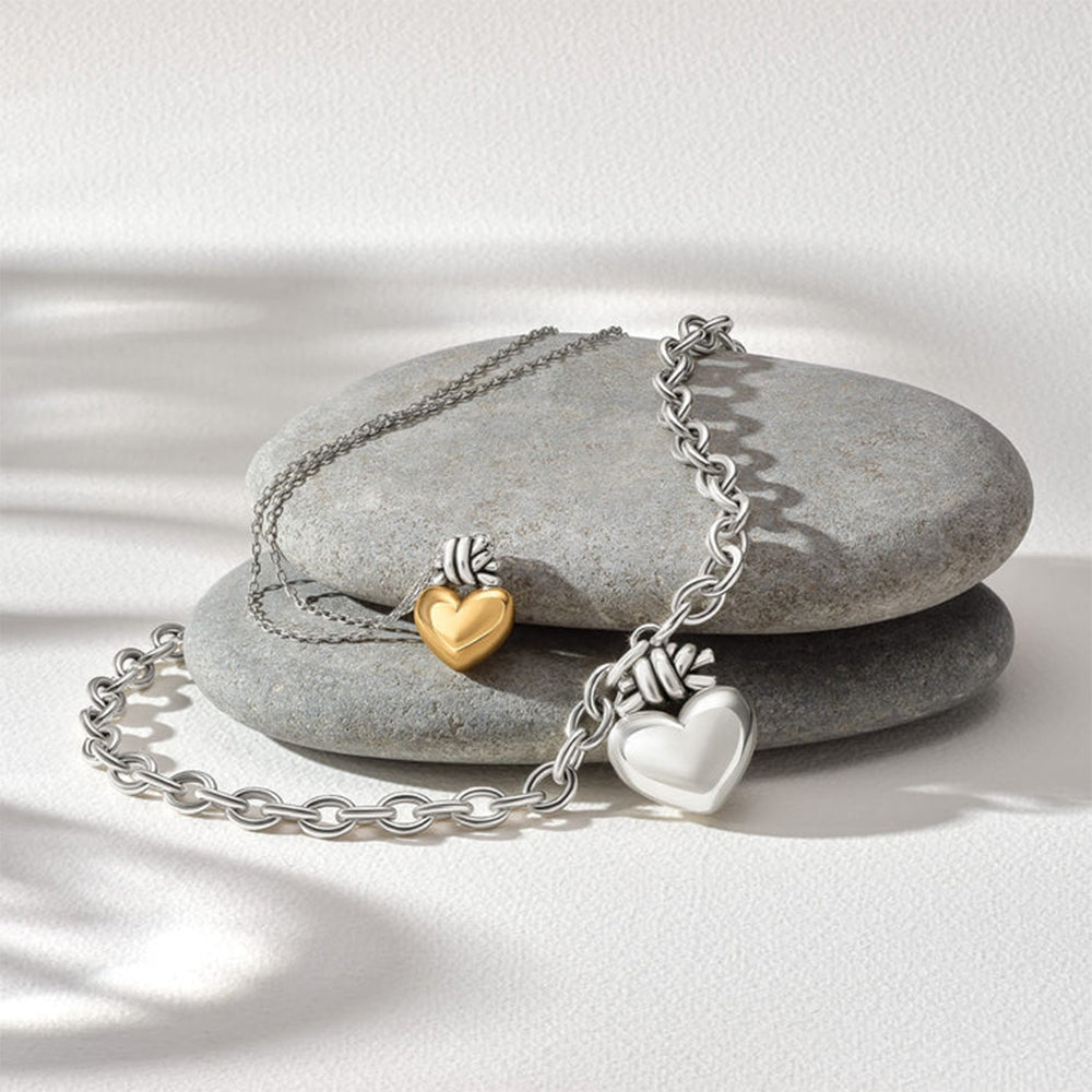 Bracelet with heart-shaped charms on a stone surface
