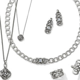 Silver jewelry set with necklaces and earrings on a white background