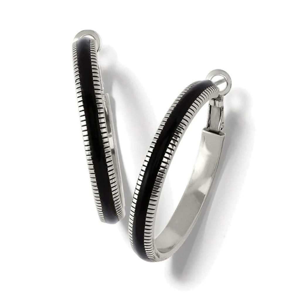 Silver and black hoop earrings on a white background