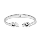 Silver bracelet with knot designs on a white background