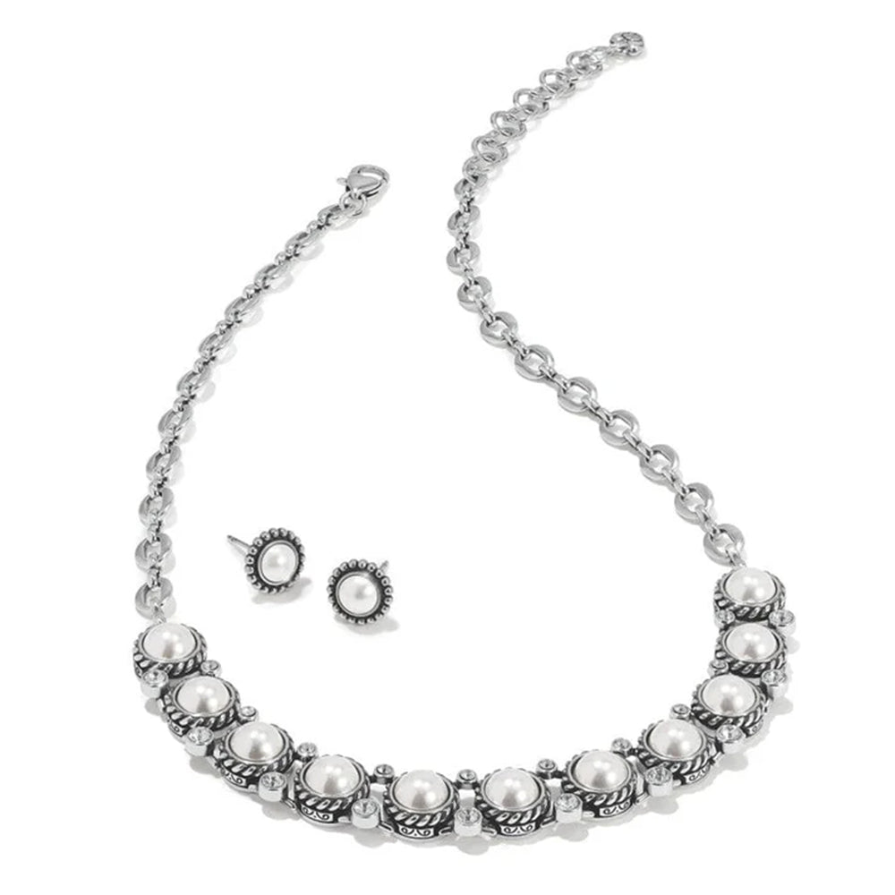 Pearl necklace and earrings set on a white background