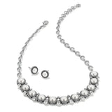 Pearl necklace and earrings set on a white background