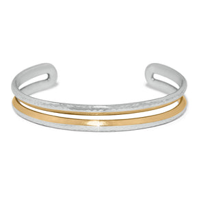 Stack of silver and gold bangles on a white background