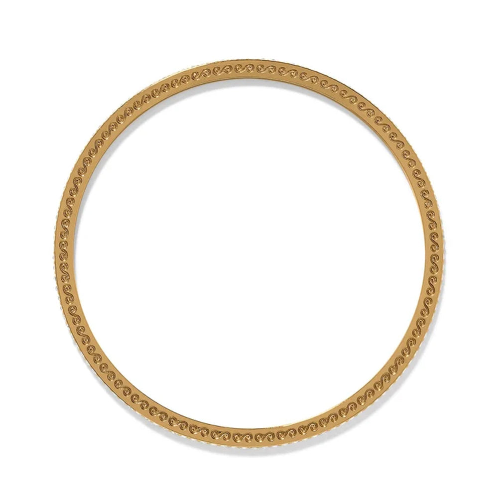 Gold bangle with intricate design on a white background