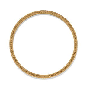 Gold bangle with intricate design on a white background