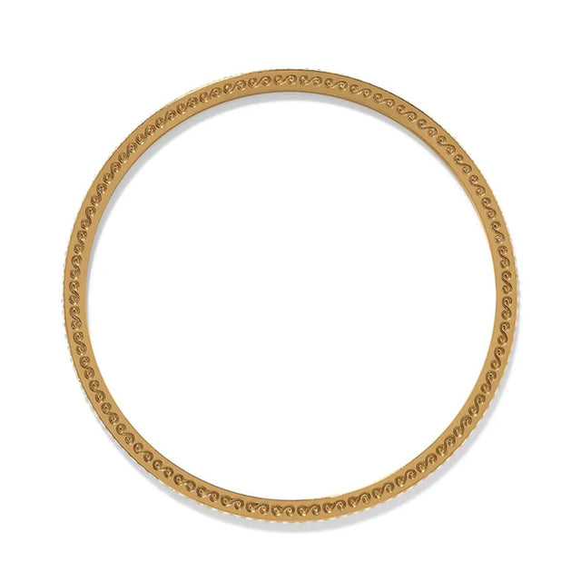 Gold bangle with intricate design on a white background