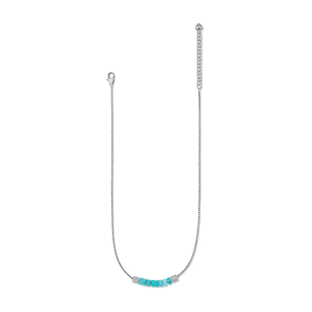 A delicate silver chain necklace featuring a small horizontal bar with turquoise-colored beads and silver spacer details, displayed on a clean white background.