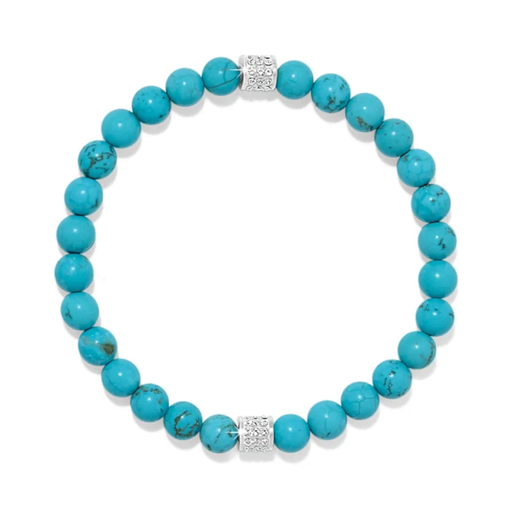 A beaded stretch bracelet made of round turquoise-blue beads with two silver-toned spacer beads set with small clear stones, shown on a plain white background.