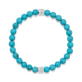 A beaded stretch bracelet made of round turquoise-blue beads with two silver-toned spacer beads set with small clear stones, shown on a plain white background.
