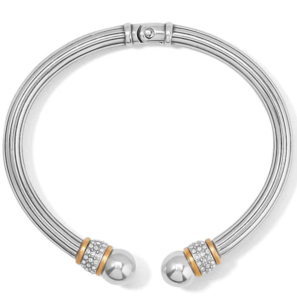 Silver bracelet with spherical ends and gold accents on a white background