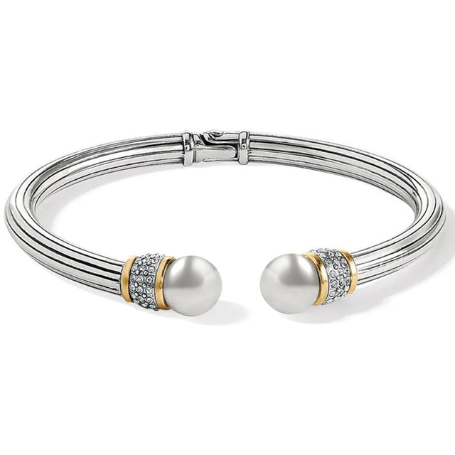 Silver bracelet with pearl-like beads on a white background