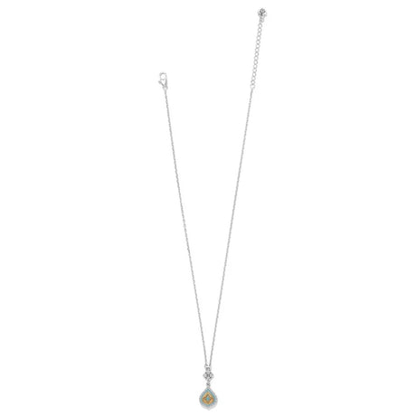 A delicate silver-toned necklace featuring a small teardrop-shaped pendant with a light blue-green iridescent center, displayed against a solid white background.