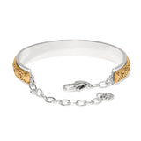Silver and gold bracelet on a white background