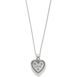 Heart-shaped pendant with 'LOVE' engraving on a chain against a white background