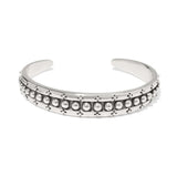 Silver bracelet with bead detailing on a white background