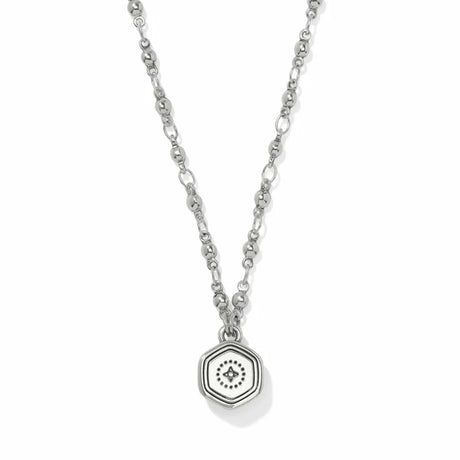 A silver-toned necklace featuring a delicate chain and a hexagonal pendant with an eye motif, displayed against a clean white background.