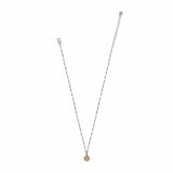 A delicate silver chain necklace with a small circular gold pendant featuring a central clear stone, displayed on a solid white background.