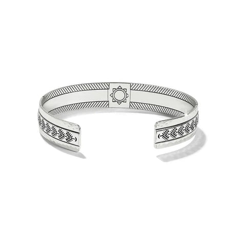 Silver bracelet with engraved patterns on a white background
