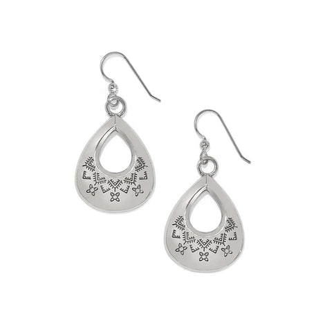 Pair of silver teardrop-shaped earrings with intricate designs on a white background