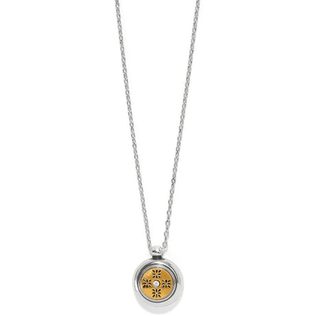 Silver necklace with a round pendant featuring a floral design on a white background