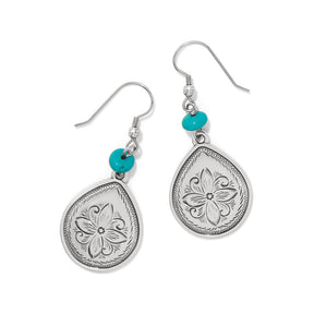 Silver teardrop earrings with butterfly designs and turquoise beads on a white background
