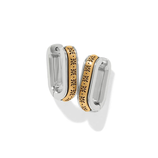 A pair of silver-toned hoop earrings with a central gold-toned band featuring a laser-cut floral pattern, shown on a clean white background.